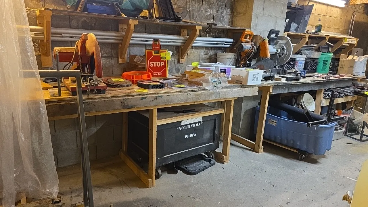 Wood workbench table and wood cart. Table measures 17' x 3' x 3'3". Cart measures 3' x 2' x 2'3" and is mounted on casters. Contents not included.