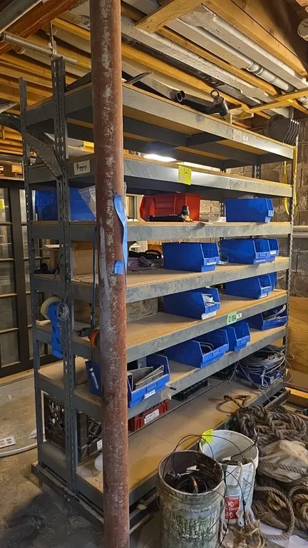 Metal portable 7-tier drop-in warehouse shelving units. Features compressed wood shelf decking and mobile caster base. Includes assorted hardware, rig