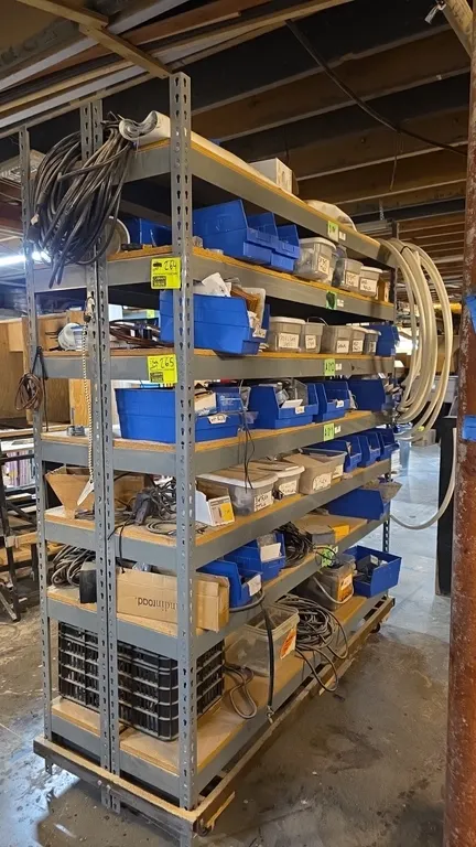 Metal portable 7-tier warehouse racking. Features drop-in compressed wood decking shelves and a mobile base with casters. Includes contents consisting