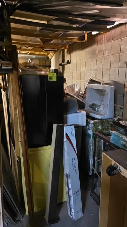Assorted plumbing fixtures and appliances lot. Includes vintage stove/range, various porcelain and stainless steel sinks, drinking fountain basin, toi