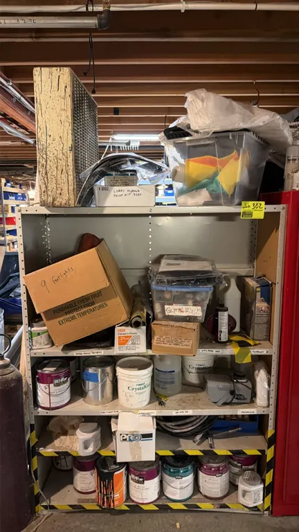 Multi-tier metal shelving unit with assorted paint and remaining contents. Includes paint cans, Rosco CrystalGel containers, The Fog Machine with fog
