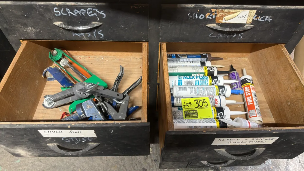 Assorted caulk guns and caulk tubes. Includes various manual caulk guns and an assortment of caulk and sealant tubes including DAP Alex Plus, DAP Fire