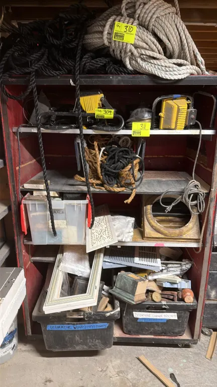 Assortment of work lights and shelving contents. Includes portable work lights, rope, decorative trim pieces, picture frames, and storage bins. Note: