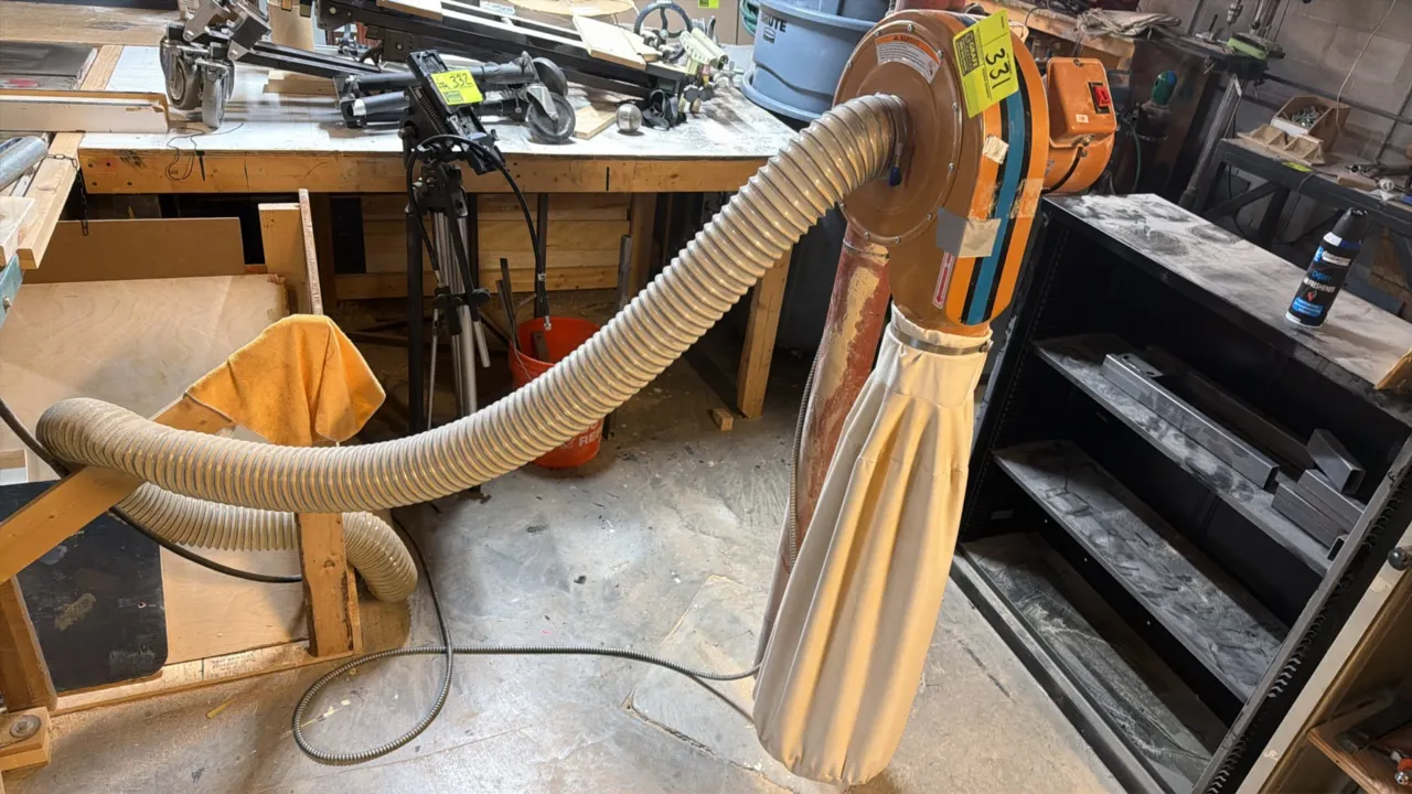 2015 Rockler 42400 wall-mount dust collector. Features 3/4 HP induction motor, lower collection filter bag, flexible intake hose, and mounting bracket