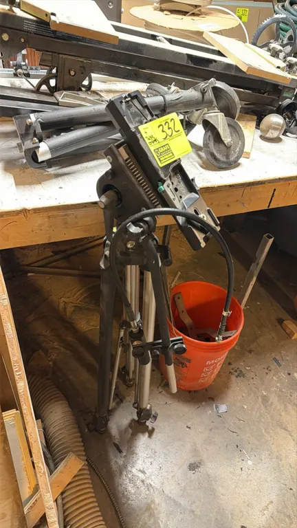 JVC KA-510U tripod system with assorted table contents. Includes tripod legs with mounting head adapter, folding wheeled tripod dollies, and camera tr