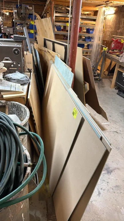 Assorted wood boards, plywood, and pressboard panels. Includes various sheet materials, composite panels, and cutoffs in assorted sizes and finishes.