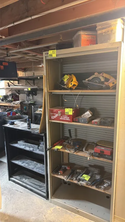 Assorted metal shelving units. Includes (1) tall tan metal unit with adjustable shelves and (1) black 3-shelf metal bookcase unit. Contents not includ