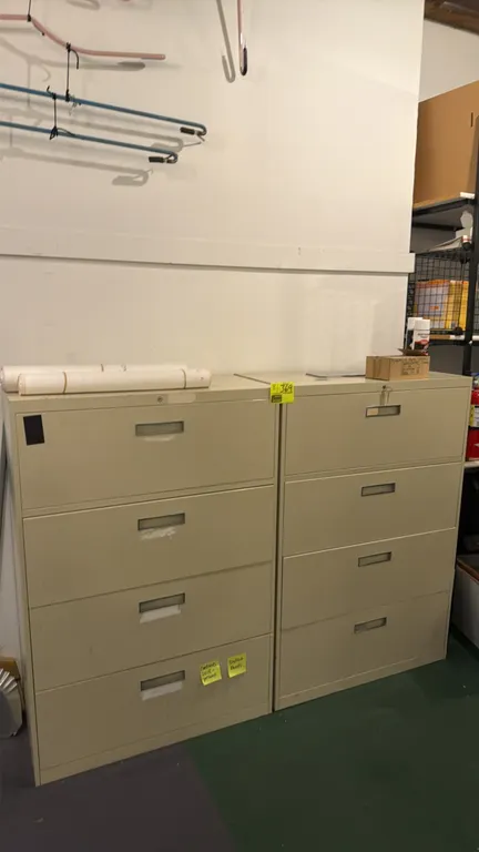 Metal 4-drawer lateral filing cabinets. Features beige painted metal construction, recessed drawer pulls, and integrated label holders. 36"W each. Con