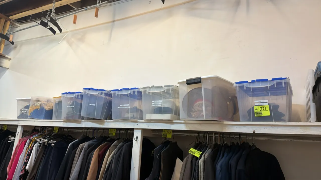 Poly storage totes with assorted dressing room contents. Clear plastic containers with lids containing assorted costume and wardrobe accessories, incl