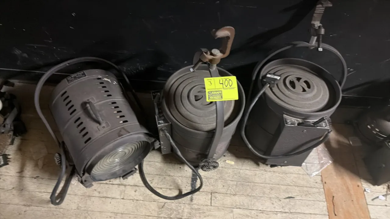 Kliegl Bros. 44Q10 vintage theater spotlights. Features Fresnel lenses, vented housing, top carry handles, and adjustable mounting yokes with pipe C-c