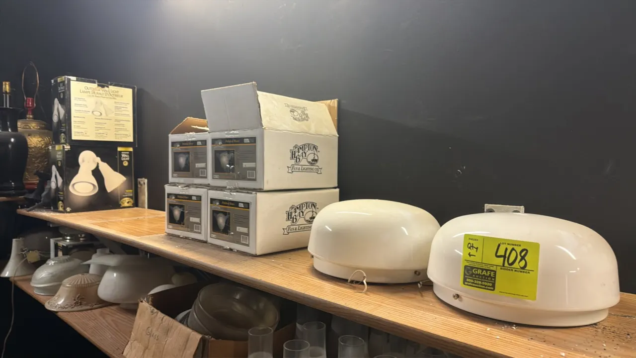 Assorted lighting fixture lot. Includes (4) boxed Hampton Bay polished brass and frosted glass wall sconces (Model 06019), (2) boxed Hampton Bay outdo
