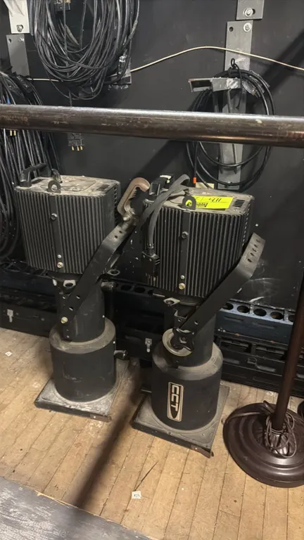 CCT theater spotlight fixtures. Features mounting yokes with clamps, ribbed lamp housings, and 3-pin stage plugs. Electrical: 120V.