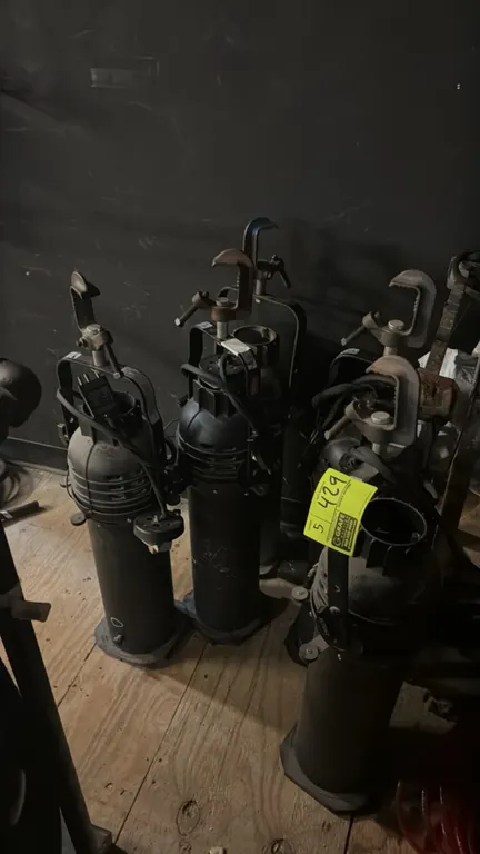 Assorted stage lighting fixtures. Includes Altman ellipsoidal spotlight fixtures with mounting yokes and C-clamps. Electrical: 120V.