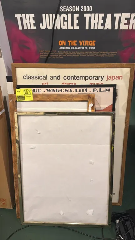 Assorted framed posters and poster board signs. Lot includes theatrical, exhibition, and vintage reproduction prints including "The Jungle Theater Sea