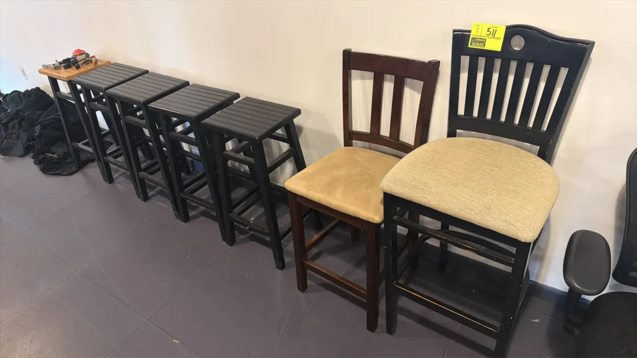 Assorted bar and counter stools. Includes (4) black wooden backless stools with slatted tops, (1) two-tone stool with natural wood top and black frame