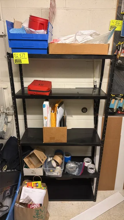 5-shelf metal light-duty storage rack with contents. Features black finish and adjustable shelves. Includes assorted office supplies, tape, and storag