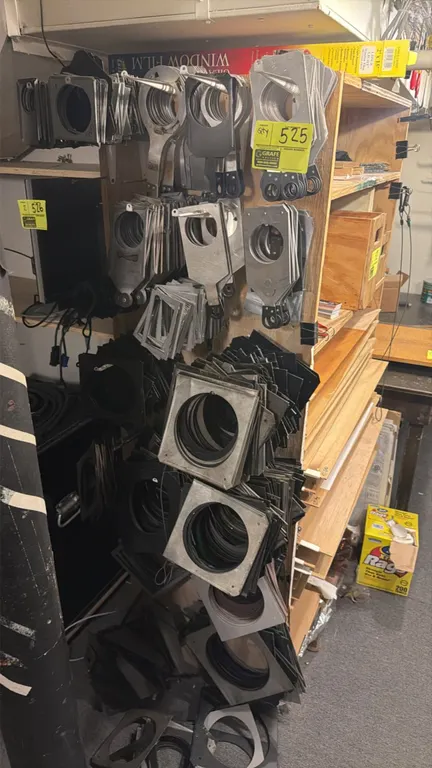 Assorted theatrical stage lighting gel frames and gobo holders. Features various sizes, styles, and finishes of metal color frames and filter holders.