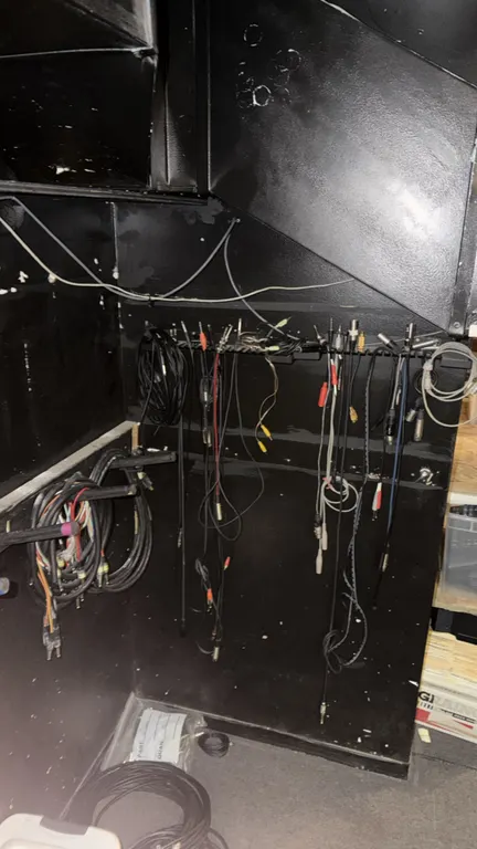 Assorted theater and stage audio/visual wiring and cables. Includes various XLR cables, patch cords, multi-pin connectors, extension cords, and a plas