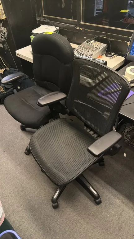 Assorted office chairs. Includes (1) black mesh ergonomic task chair and (1) black fabric upholstered task chair. Features armrests and pneumatic heig