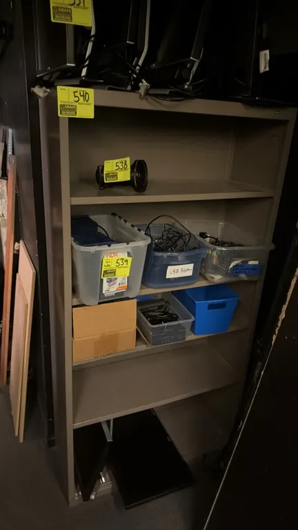Metal shelving unit. Features adjustable shelves and durable steel construction. 3' x 1' x 5.5'. Contents not included.