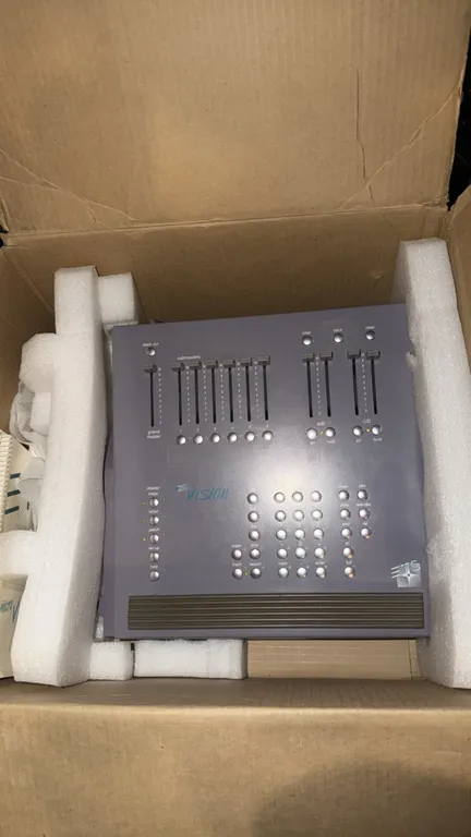 ETC MicroVision theatrical lighting control console. Features grand master fader, submaster faders, dual crossfaders, and programming keypad.