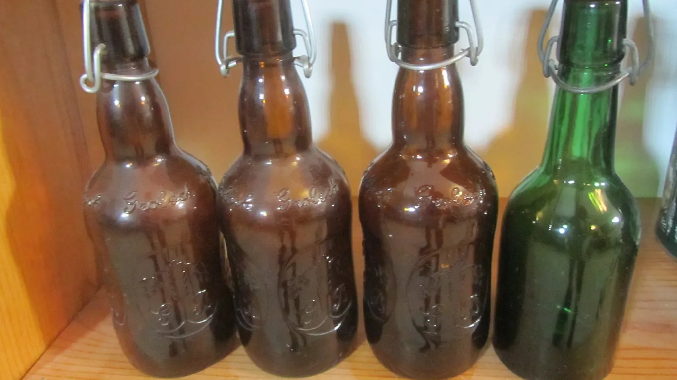 (3) Vintage Brown Glass Grolsch Bottles And (1) Vintage Green Glass Bottle