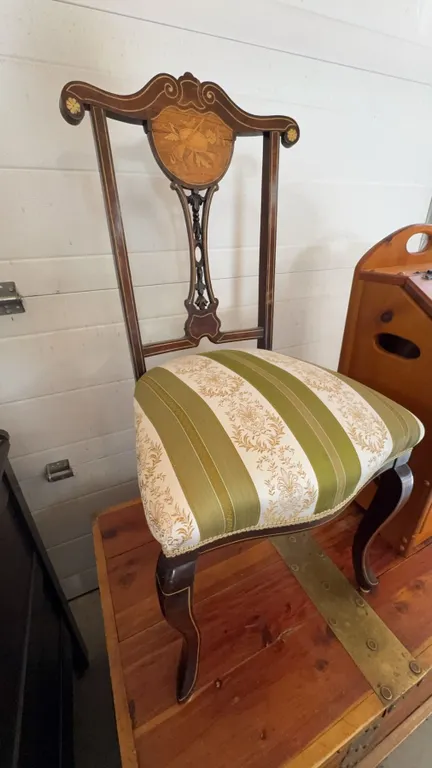 1800s vintage Wood side chair with floral and musical motif inlaid crest. Features decorative carved