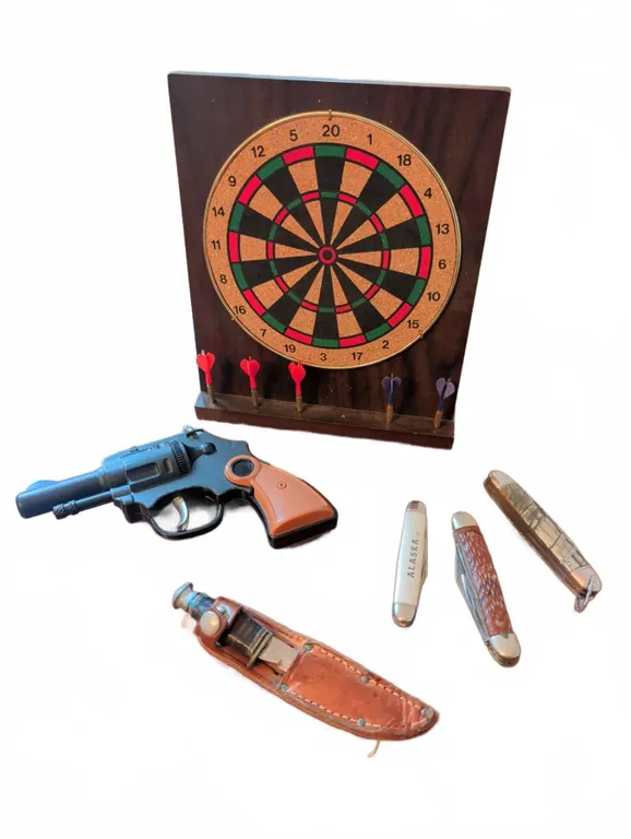 Dartboard, Toy Cap Gun, Pocket Knives and Sheathed Fixed Blade Knife Lot