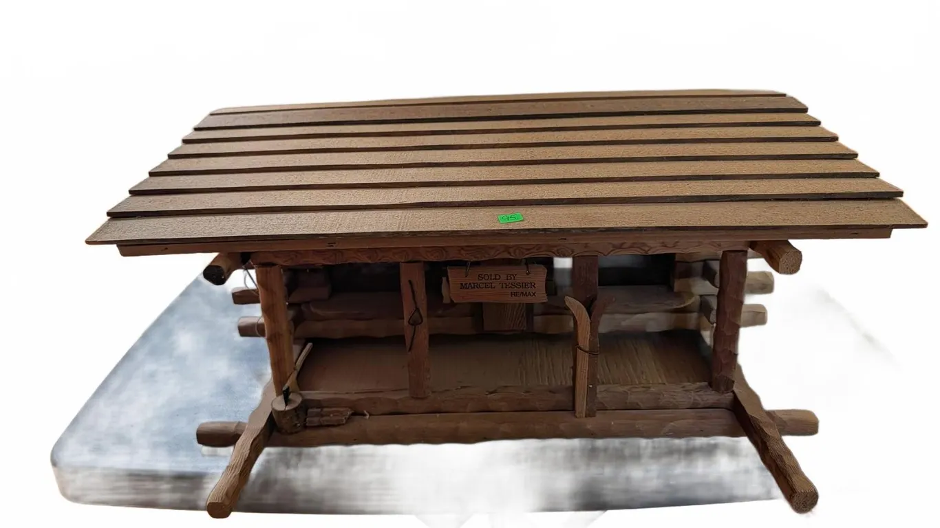 Wooden Log Cabin Model with 'Sold by Marcel Tessier RE/MAX' Sign