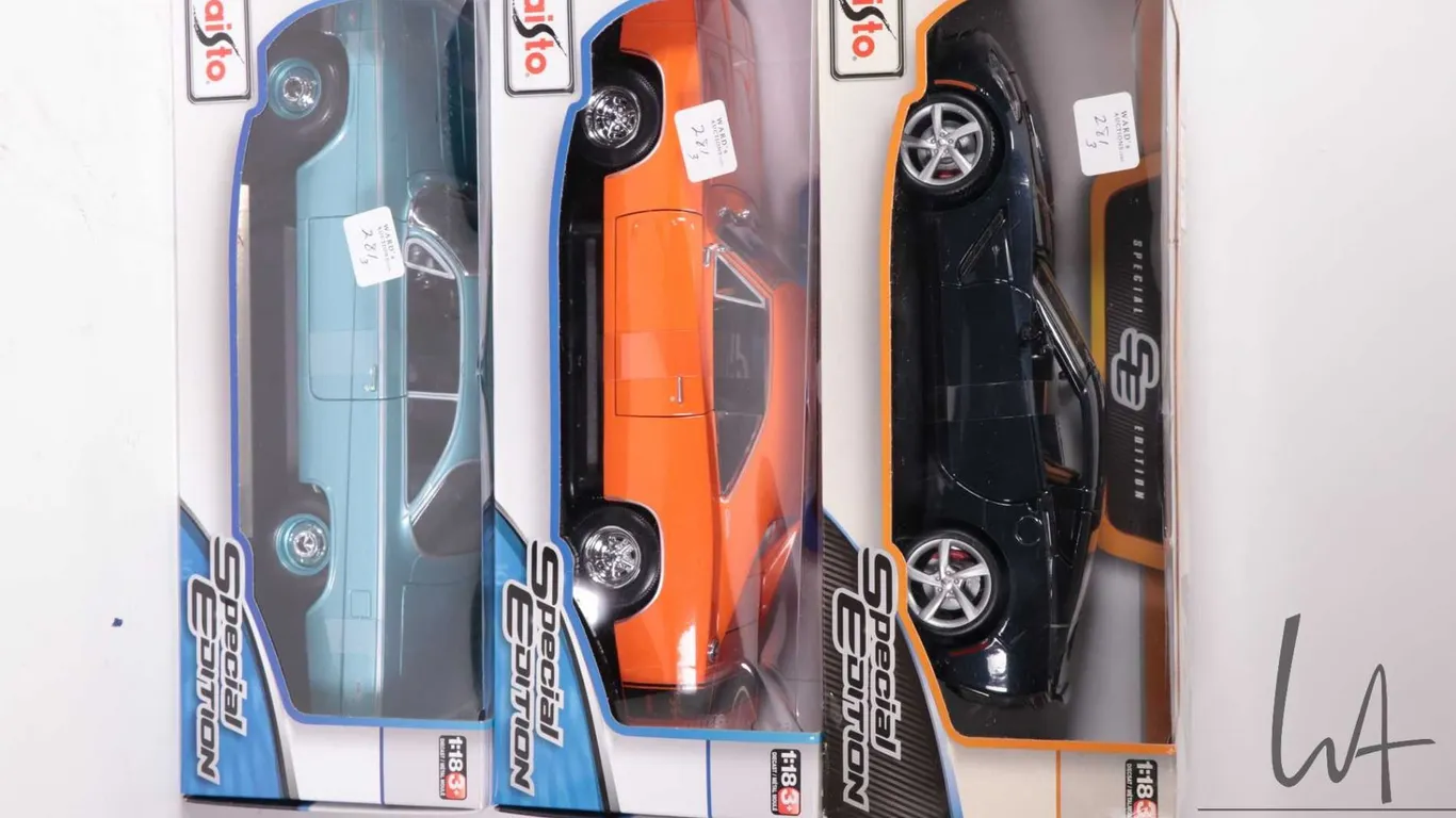 Three Maisto die cast model cars including a 2014 Corvette Stingray, 1969 Dodge Charger R/T and a 19