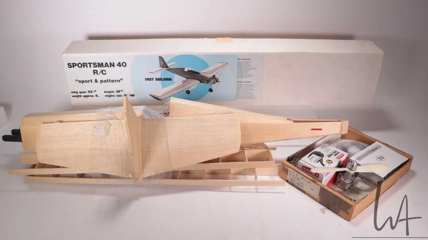 A partially assembled Sportsman 40 RC Sport & Pattern wooden model airplane, 24LA-S OS engine, Hanga