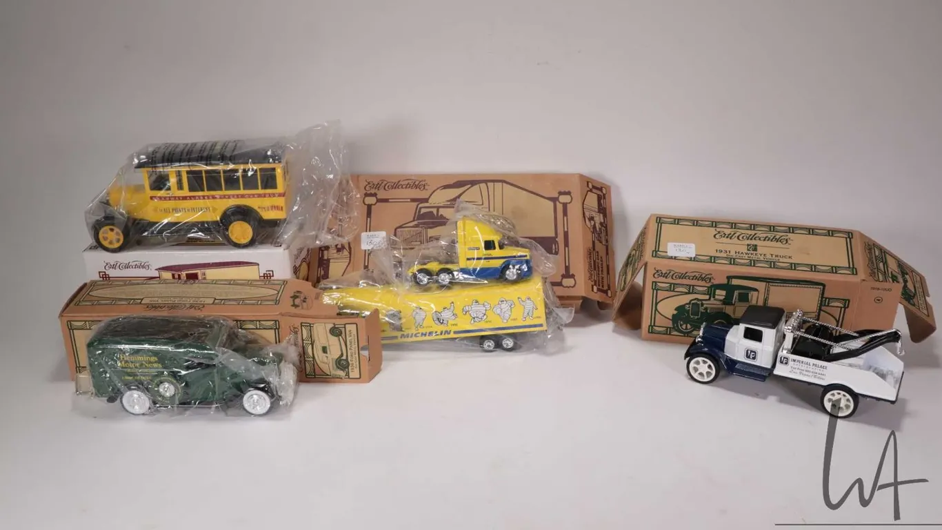 Four Ertl collectible die cast banks including 1936 Ford Panel Van 1927 Graham Panel Van, 1931 Hawke