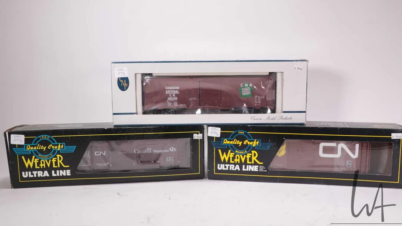 Two Weaver Ultra Line box cars and a Crown Model Products box car, all O gauge CN Rail