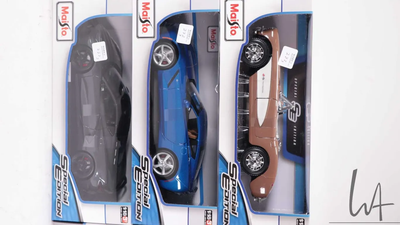 Three Maisto die cast model cars including a 1957 Chevrolet Corvette, a 2014 Corvette Stingray and a