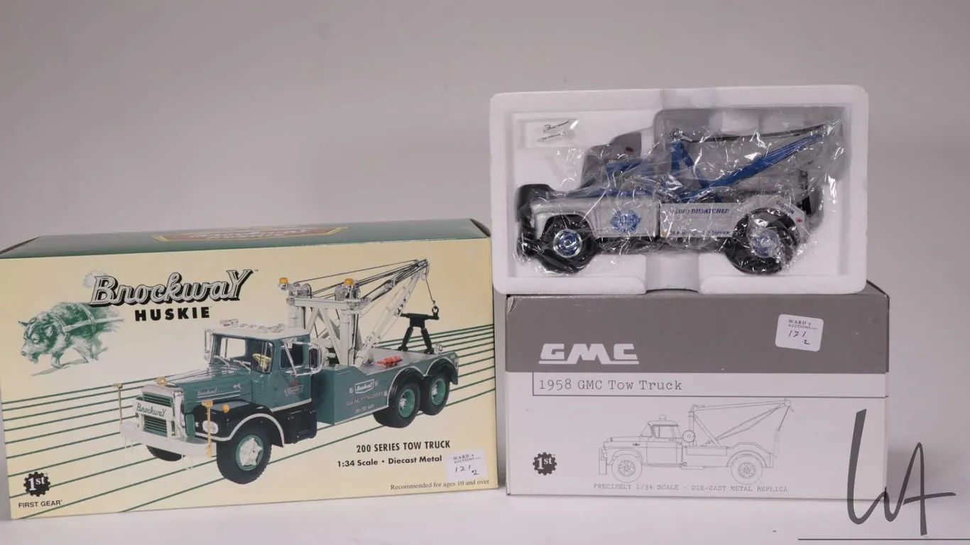 Two 1st Gear 1:34 scale die cast vehicles including 200 Series Mack Tow Truck and a 1958 GMC Tow Tru