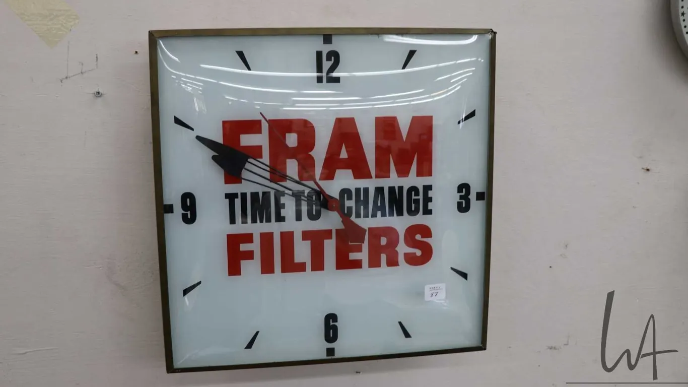 Fram Filters illuminating electric wall clock, 15" square, working at time of cataloguing, needs new