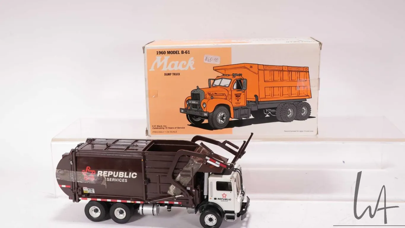 Two 1st Gear die cast 1:34 scale Mack Trucks including a 1960's Model B-61 and a garbage truck