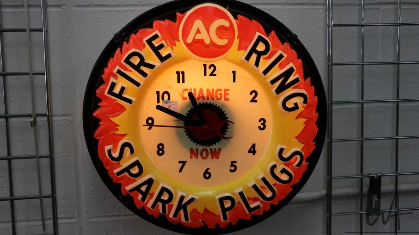 Vintage molded plastic electric AC Fire Ring Spark Plugs illuminating wall clock, working at time of