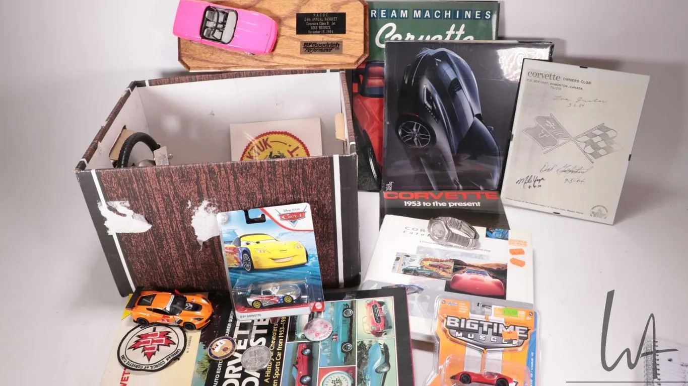 Selection of Corvette collectable items including die cast cars, badges, calendars, pins, books, etc