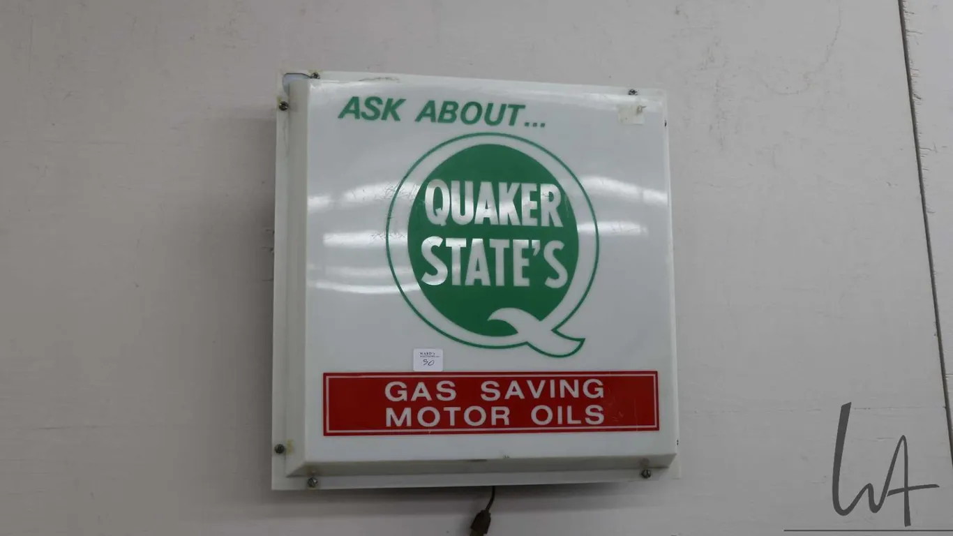 Molded plastic Quaker State Motor Oil illuminating electric advertising sign, working at time of cat
