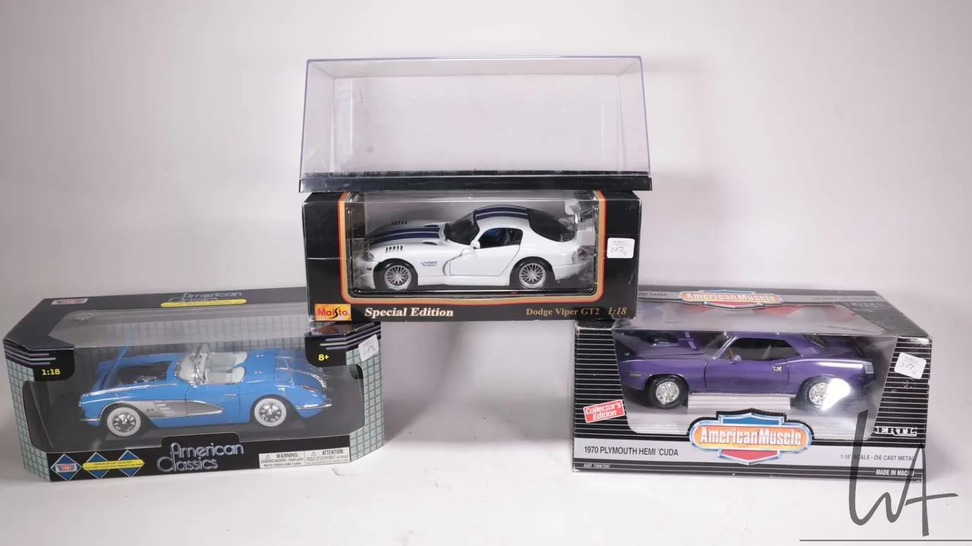 Three die cast model cars including Maisto Dodge Viper GT2, Ertl American Muscle 1970 Plymouth Hemi