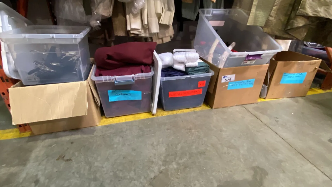 4 STORAGE BINS OF SKIRTING AND 1 BIN OF FOOTWEAR