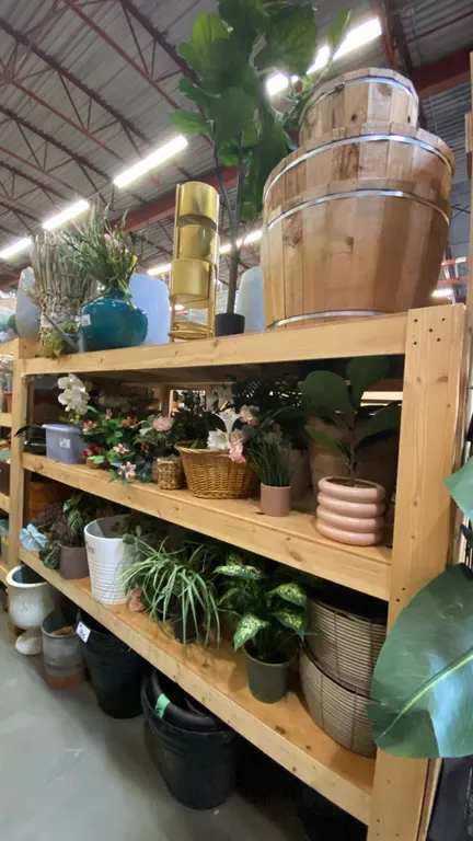 4 SHELVES FULL OF ASSORTED DECORATIVE PIECES -ARTIFICIAL PLANTS AND FLOWERS, PLANTERS AND STANDS