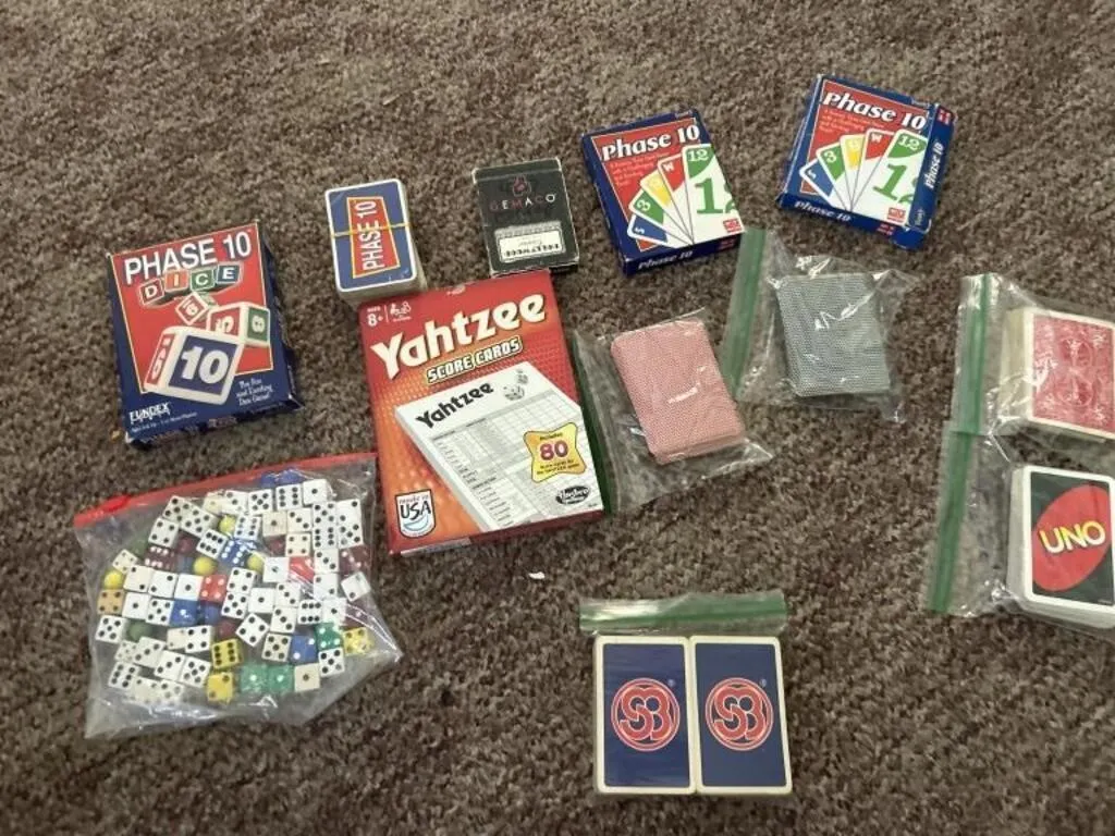 Phase 10 dice, 3 phase 10 cards, 4 playing