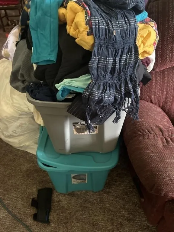 Two totes filled with clothing