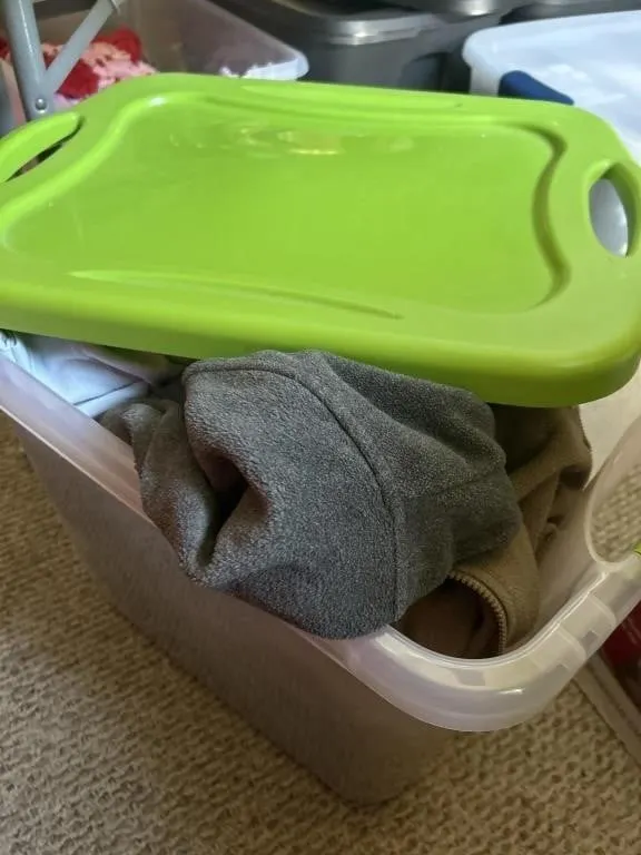Tote full of sweatshirts and shirts