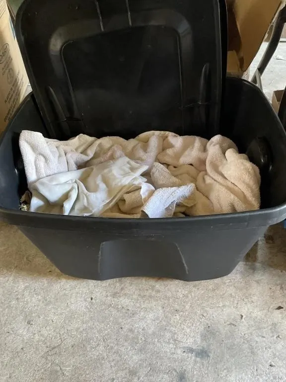 Two plastic totes with lids and towels