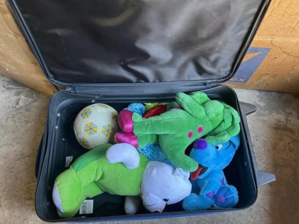 Blue suitcase with stuffed animals