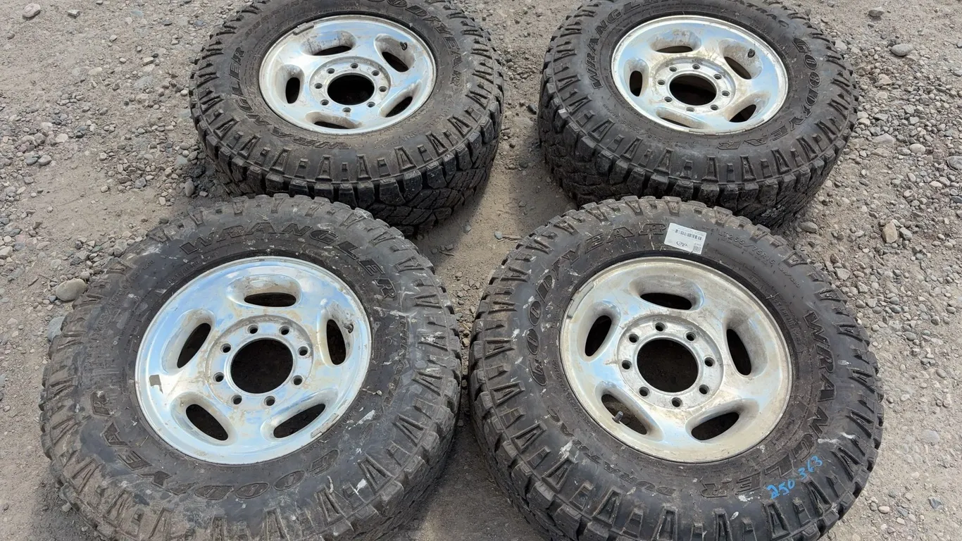 4 - Goodyear Wrangler LT265/75R16 Studded Tires, Rims & Hub Caps Off '01 Dodge 2500