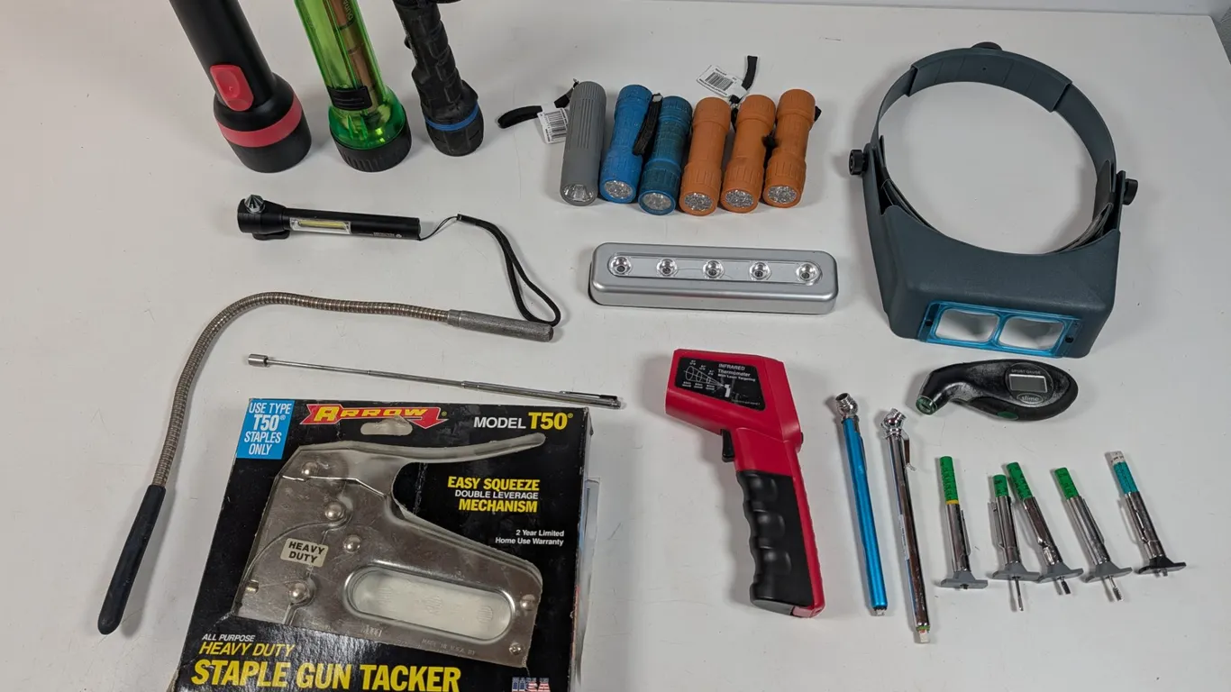 Lot of flashlights magnetic retrieving tools tire pressure gauges a magnifying heat gear and Arrow T